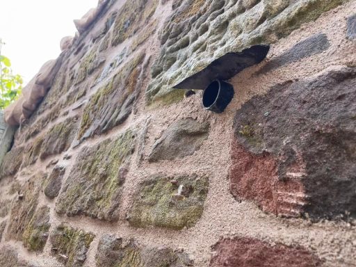 Original sandstone wall re-pointed in Woolton, South Liverpool using traditional lime mortar